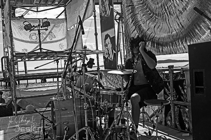 The drummer from behind the kit, pushed to high-contrast black and white.