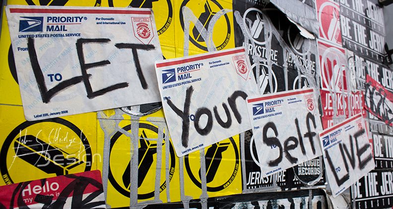 The sticker wall at Studio 7 — years of touring bands layered over each other.