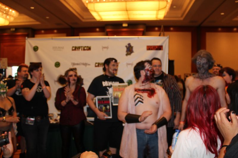 Crypticon 2012 — cosplayer holding a character pose against the convention backdrop