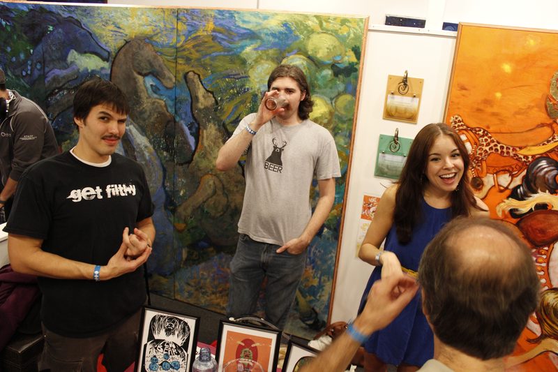 Artists beside their pieces — artwork by the exhibiting artists