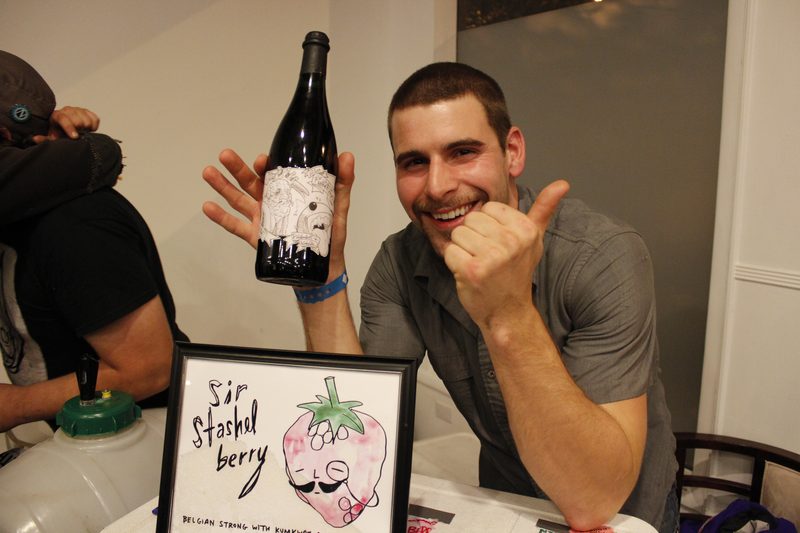 A brewer with his bottle and its label art — label artwork by the exhibiting artist